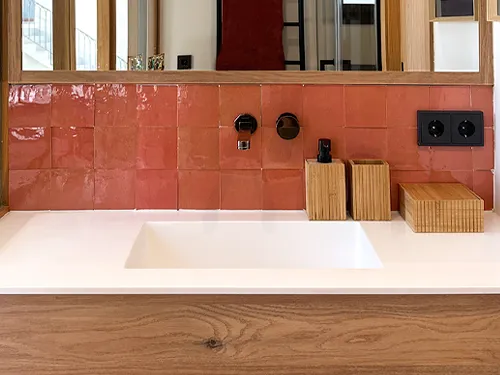 Bathroom wall featuring red zellige tiles